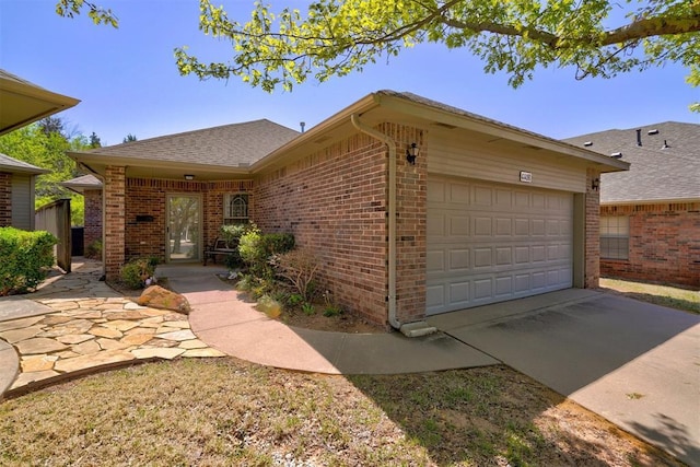 4408 32nd Pl, Oklahoma City, OK 73112 - ranch-style home featuring brick siding, an attached garage, driveway, and roof with shingles