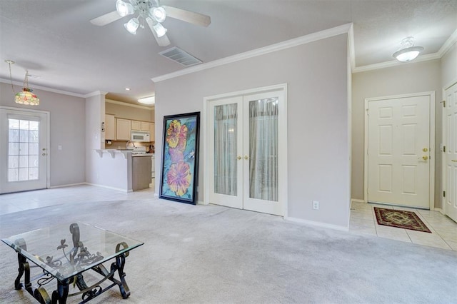 4408 32nd Pl, Oklahoma City, OK 73112 - unfurnished living room with crown molding, light colored carpet, visible vents, french doors, and baseboards