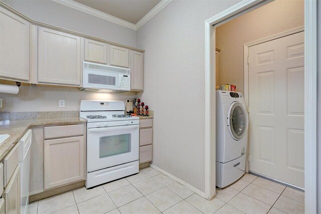 4408 32nd Pl, Oklahoma City, OK 73112 - kitchen with crown molding, white appliances, light stone countertops, light tile patterned flooring, and washer / dryer