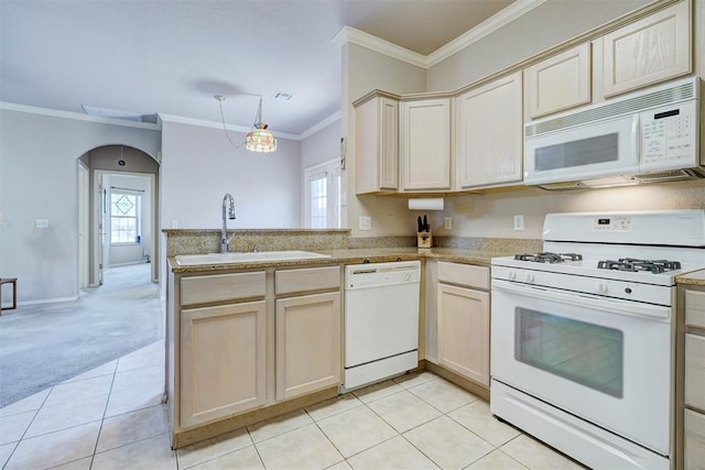 4408 32nd Pl, Oklahoma City, OK 73112 - kitchen featuring ornamental molding, white appliances, a peninsula, visible vents, and a sink