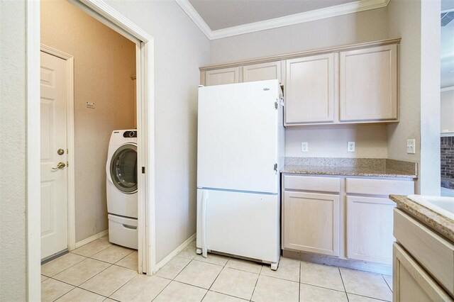 4408 32nd Pl, Oklahoma City, OK 73112 - kitchen featuring ornamental molding, light tile patterned floors, freestanding refrigerator, light stone countertops, and washer / dryer