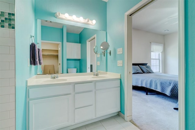 4408 32nd Pl, Oklahoma City, OK 73112 - full bathroom featuring double vanity, a sink, tile patterned flooring, and connected bathroom