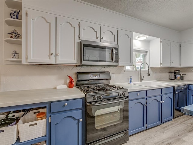 kitchen featuring white cabinetry, blue cabinetry, open shelves, black appliances, and a sink