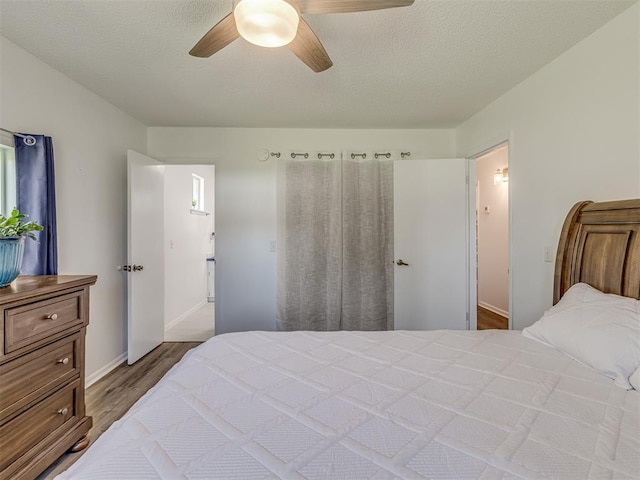 bedroom with wood finished floors, ceiling fan, and baseboards