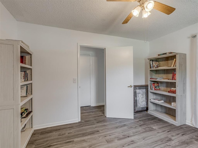 interior space with ceiling fan