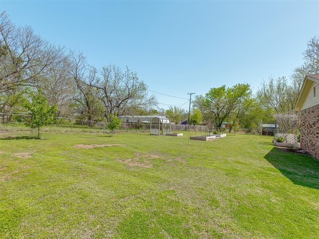 view of yard featuring a vegetable garden and fence