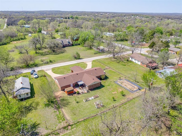 drone / aerial view featuring a wooded view