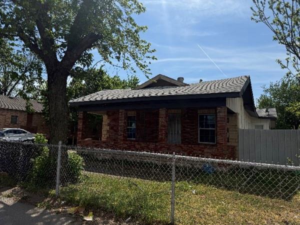 4115 S Shields Blvd, Oklahoma City, OK 73129 - view of side of property featuring brick siding and a fenced front yard