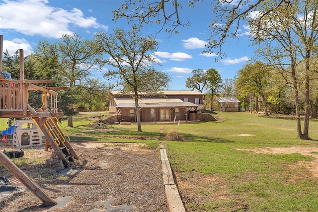 view of yard featuring an outdoor structure and a playground