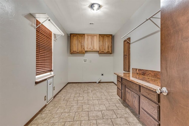laundry area with cabinet space, baseboards, hookup for an electric dryer, and hookup for a washing machine