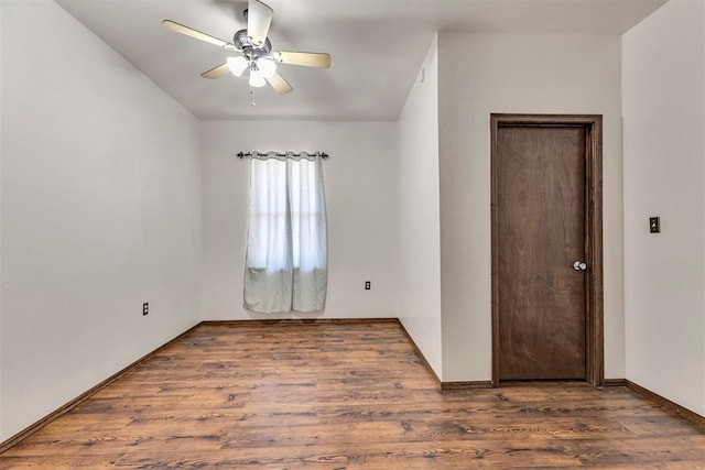 spare room featuring a ceiling fan and wood finished floors
