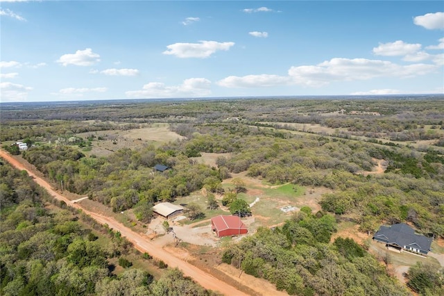 drone / aerial view featuring a wooded view