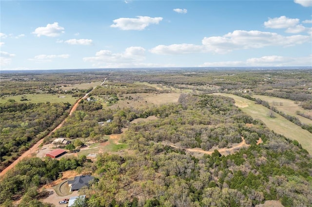 birds eye view of property with a view of trees