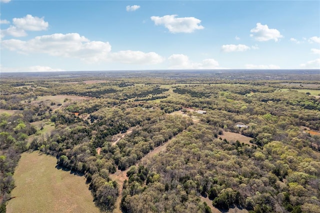 birds eye view of property with a view of trees