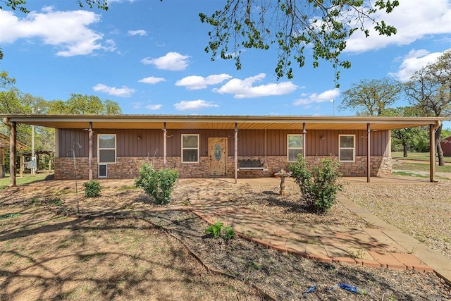 ranch-style house featuring board and batten siding and stone siding