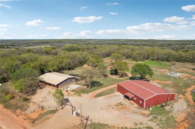 birds eye view of property with a view of trees
