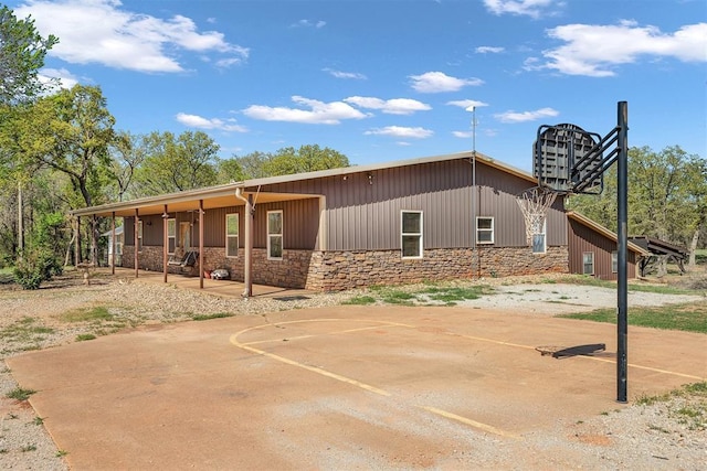 view of front of property with uncovered parking and stone siding