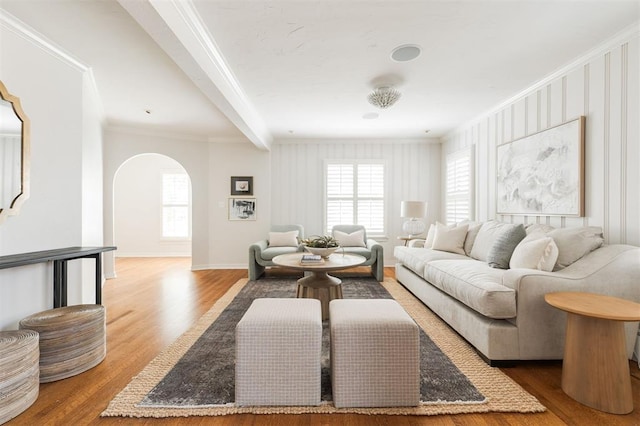 905 NW 40th St, Oklahoma City, OK 73118 - living room featuring baseboards, arched walkways, crown molding, beam ceiling, and wood finished floors