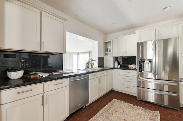 905 NW 40th St, Oklahoma City, OK 73118 - kitchen featuring dark stone countertops, a sink, appliances with stainless steel finishes, recessed lighting, and decorative backsplash