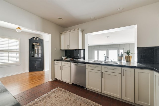 905 NW 40th St, Oklahoma City, OK 73118 - kitchen with a sink, stainless steel dishwasher, a wealth of natural light, and decorative backsplash