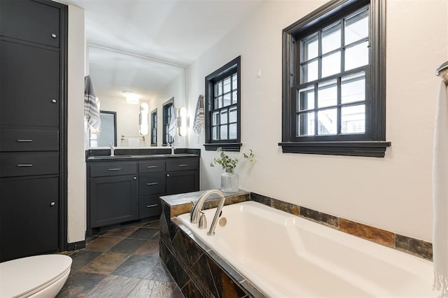 905 NW 40th St, Oklahoma City, OK 73118 - full bath with vanity, stone tile floors, a garden tub, and toilet