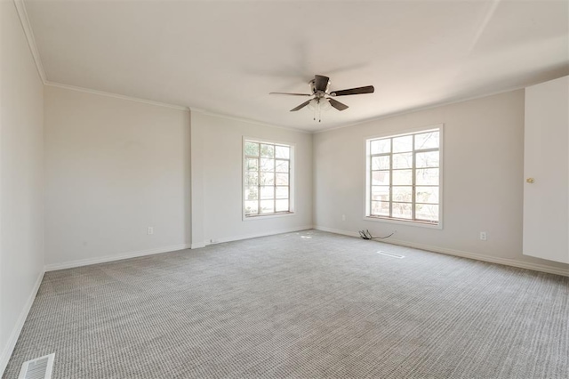 905 NW 40th St, Oklahoma City, OK 73118 - carpeted spare room with visible vents, baseboards, a ceiling fan, and ornamental molding