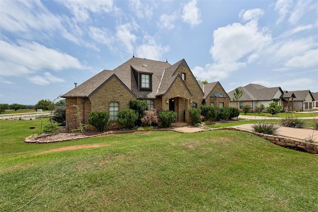 2293 Cottage Ln, Blanchard, OK 73010 - french country style house with a front yard, brick siding, stone siding, and a shingled roof