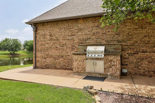 2293 Cottage Ln, Blanchard, OK 73010 - view of patio featuring exterior kitchen and a water view