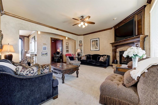2293 Cottage Ln, Blanchard, OK 73010 - living area with light colored carpet, ornamental molding, a ceiling fan, and a fireplace