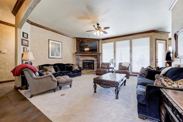 2293 Cottage Ln, Blanchard, OK 73010 - living area with a ceiling fan, crown molding, and a stone fireplace