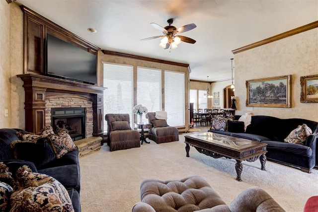2293 Cottage Ln, Blanchard, OK 73010 - living area with carpet floors, a ceiling fan, crown molding, and a stone fireplace