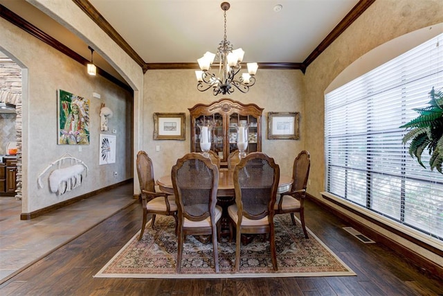 2293 Cottage Ln, Blanchard, OK 73010 - dining space featuring a chandelier, arched walkways, ornamental molding, and hardwood / wood-style floors