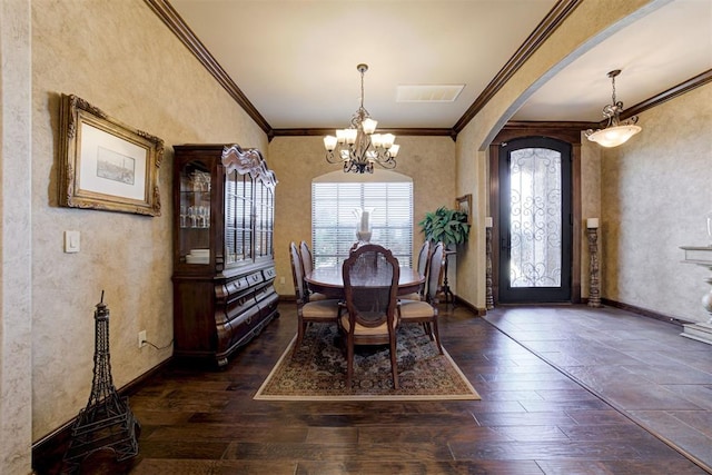 2293 Cottage Ln, Blanchard, OK 73010 - dining room featuring a chandelier, crown molding, arched walkways, and dark wood-type flooring
