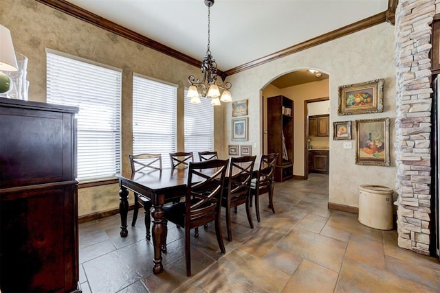2293 Cottage Ln, Blanchard, OK 73010 - dining space featuring arched walkways, crown molding, and stone finish floors