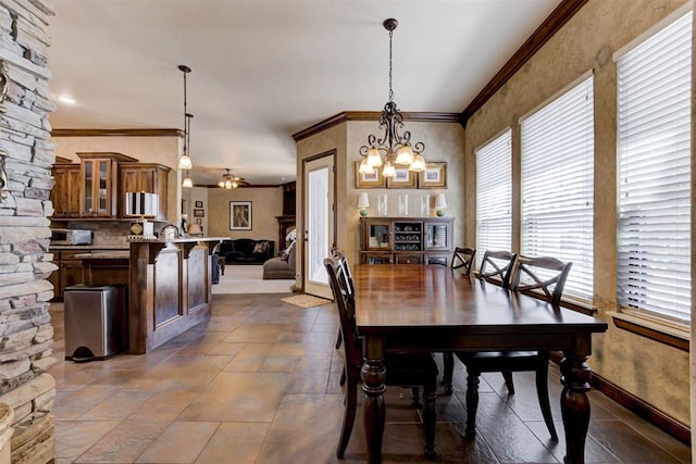 2293 Cottage Ln, Blanchard, OK 73010 - dining area featuring ornamental molding, a ceiling fan, stone tile flooring, and a chandelier