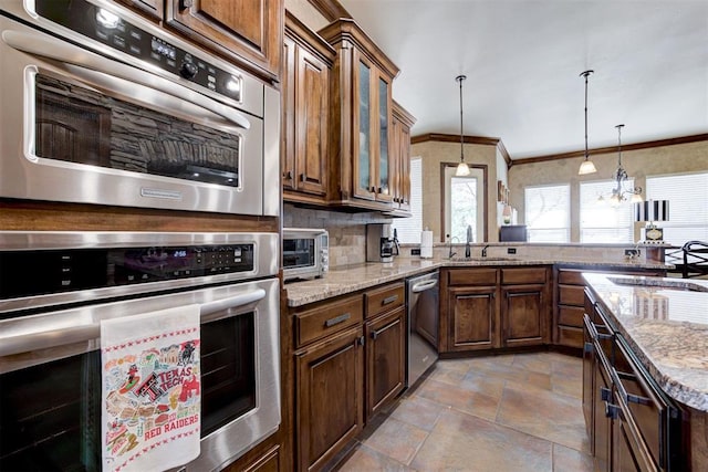 2293 Cottage Ln, Blanchard, OK 73010 - kitchen with stainless steel appliances, stone finish floors, light stone counters, decorative light fixtures, and decorative backsplash