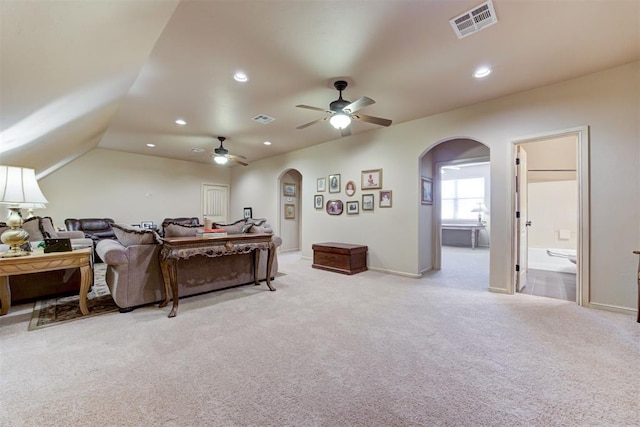2293 Cottage Ln, Blanchard, OK 73010 - living room with arched walkways, light colored carpet, ceiling fan, and recessed lighting