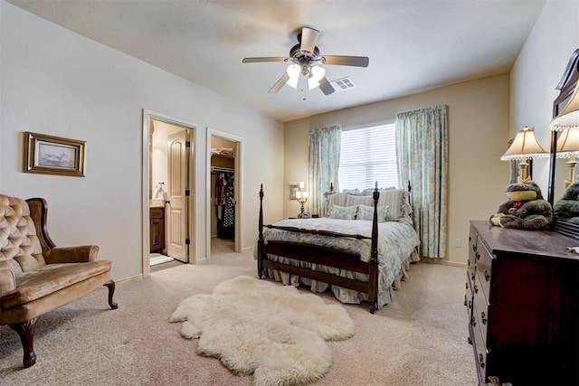 2293 Cottage Ln, Blanchard, OK 73010 - bedroom with light carpet, a walk in closet, ensuite bathroom, and a ceiling fan