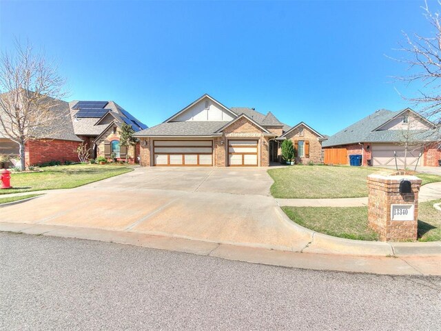 13340 Greenscape Rd, Piedmont, OK 73078 - view of front of house with a front yard, an attached garage, brick siding, and concrete driveway