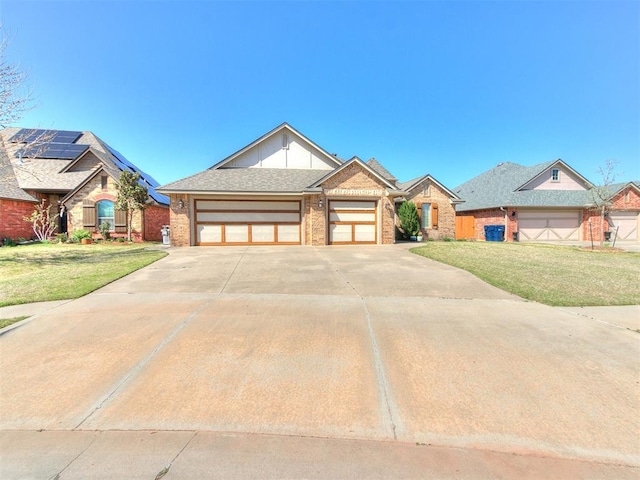 13340 Greenscape Rd, Piedmont, OK 73078 - view of front of property with a front yard, an attached garage, brick siding, and driveway