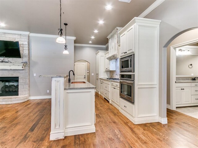 13340 Greenscape Rd, Piedmont, OK 73078 - kitchen with crown molding, light stone countertops, white cabinetry, a sink, and stainless steel appliances