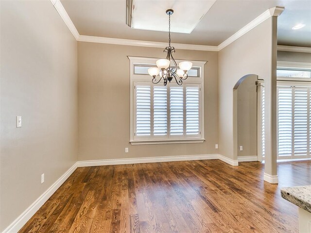 13340 Greenscape Rd, Piedmont, OK 73078 - unfurnished dining area with arched walkways, an inviting chandelier, ornamental molding, and wood finished floors