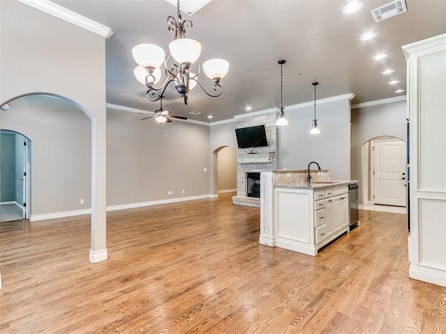 13340 Greenscape Rd, Piedmont, OK 73078 - kitchen featuring crown molding, ceiling fan with notable chandelier, a large fireplace, visible vents, and a sink