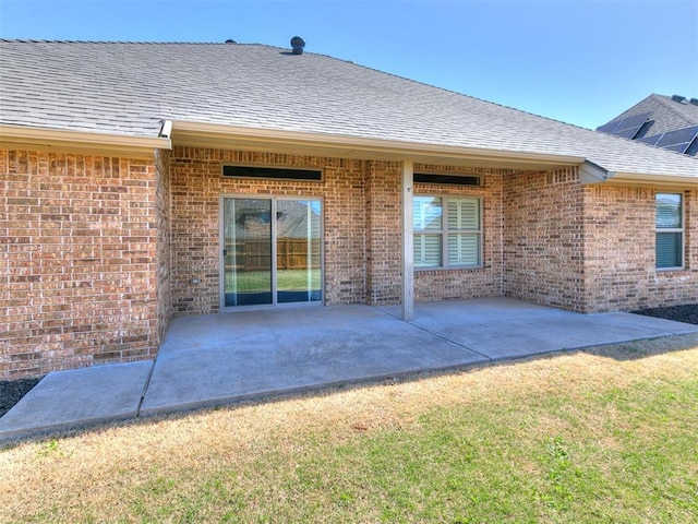 13340 Greenscape Rd, Piedmont, OK 73078 - rear view of house featuring a patio area, a shingled roof, brick siding, and a lawn
