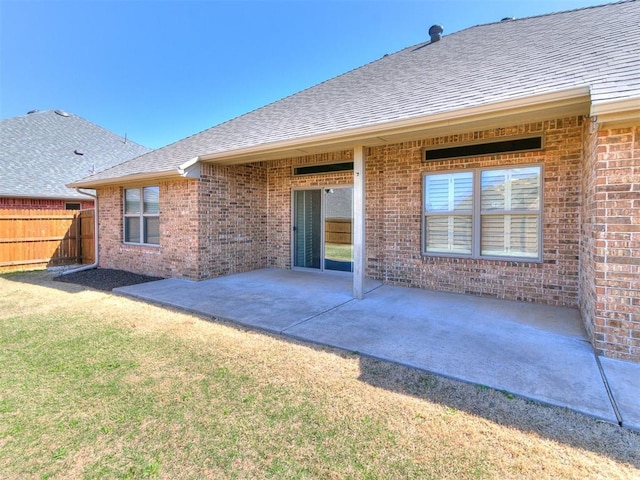 13340 Greenscape Rd, Piedmont, OK 73078 - back of property featuring a shingled roof, a patio area, fence, and brick siding
