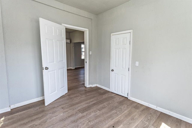 empty room featuring baseboards and wood finished floors