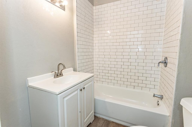 full bathroom featuring tub / shower combination, vanity, toilet, and wood finished floors