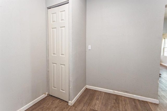 interior space featuring baseboards and wood finished floors