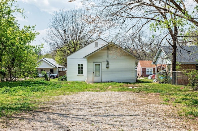 back of property featuring fence