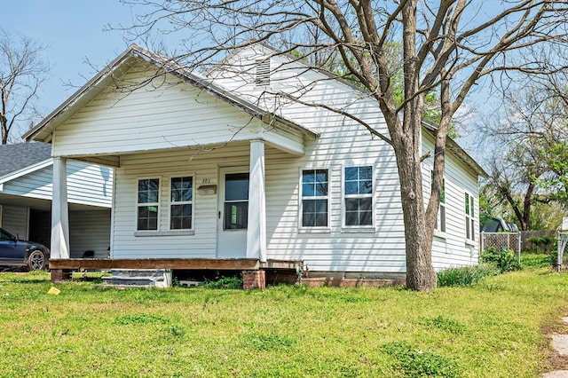 view of front of home with a carport, a front lawn, and a porch